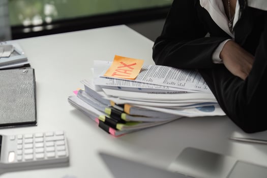 Tax documents and calculator on a desk, highlighting financial responsibilities. photo