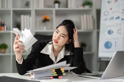 Businesswoman deeply focused on tax documents, navigating the complexities of financial reporting. photo