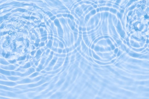 Water background,Sea blue water ripple surface texture with light effect use for Summer background banner,Top view Motion circle wave water in bathroom,Flat lay swimming pool with natural sunlight photo