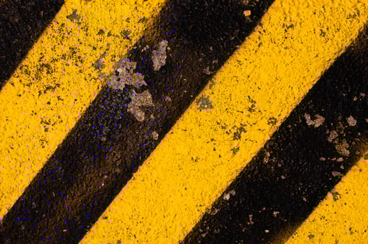 Grunge yellow and black diagonal stripes. Industrial warning background, warn caution, construction. photo