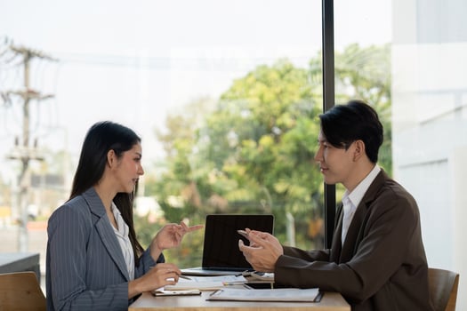 Collaboration in planning. Two professionals discussing project strategies in a modern workspace. photo