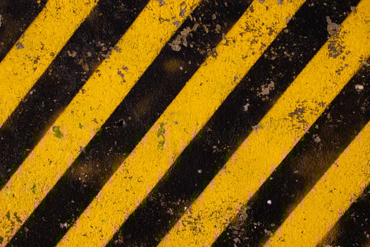 Grunge yellow and black diagonal stripes. Industrial warning background, warn caution, construction. photo