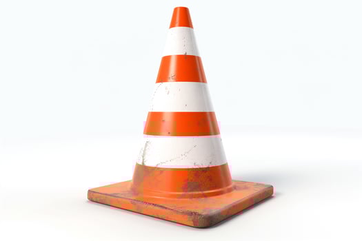 A weathered traffic cone with orange and white stripes, symbolizing road work and caution. photo