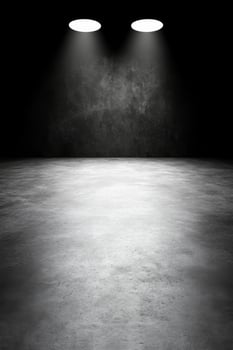 Empty Dark Room with Two Spotlights Illuminating Concrete Floor photo