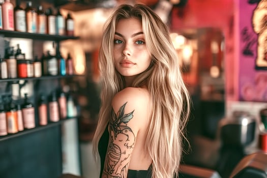 Tattooed blonde woman posing in hair salon or barbershop photo