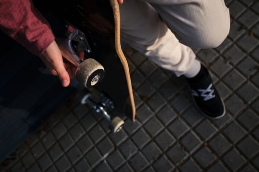 Crop skater resting on pavement photo