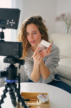 Female beauty blogger recording on camera at home photo