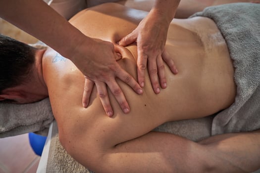 Anonymous masseuse treating client in spa salon photo