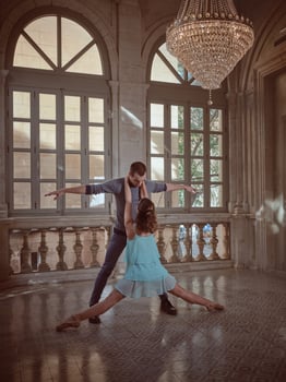 Graceful ballerina with partner dancing in palace photo