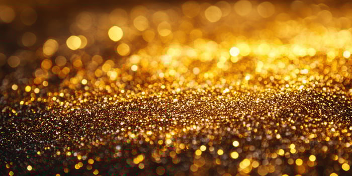 Golden glitter sparkles on a dark surface during a festive celebration or event at night photo