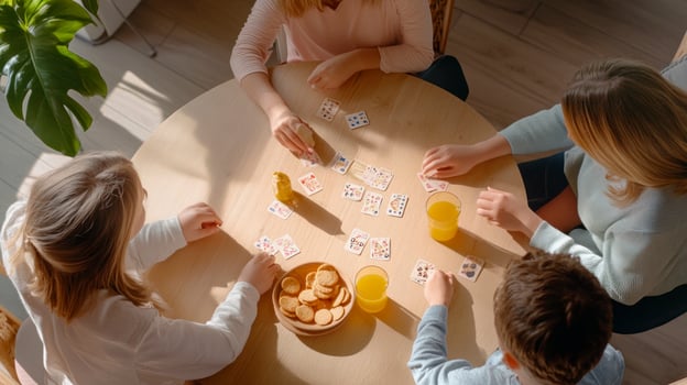 Four people playing cards at a table photo