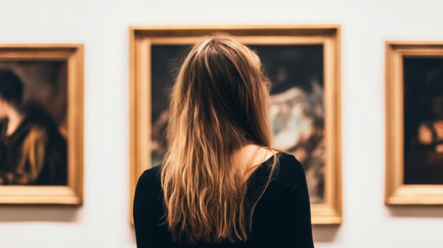 Exploring art in a gallery while admiring classic paintings in an intimate setting photo