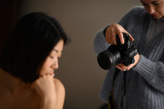 A professional photographer captures a portrait of an Asian woman, focusing on her elegance and expression. photo