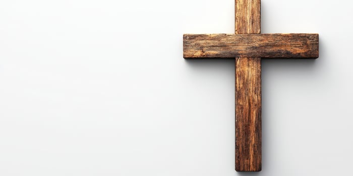 Wooden cross on a plain background representing faith and spirituality in a contemporary setting photo
