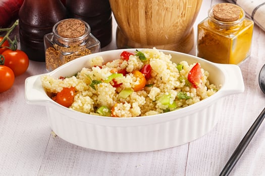 A white bowl filled with a salad on a table photo