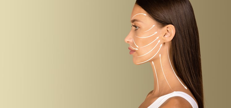 A woman enjoys a soothing skin care session, receiving a gentle facial massage designed for anti-aging and rejuvenation. Soft lighting enhances the relaxing atmosphere of the experience, copy space photo
