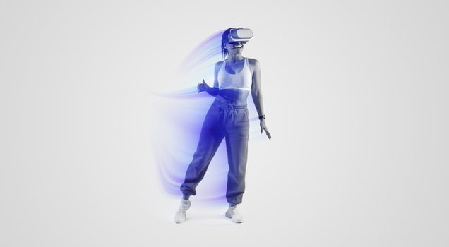 Happy African American woman dancing in virtual reality headset, enjoying her virtual reality experience while exploring 3D technology over pink neon light background, full length photo