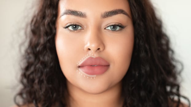 A woman enjoys a soothing facial massage aimed at anti-aging and skin rejuvenation. She relaxes in a serene atmosphere, enhancing her beauty with effective skincare practices. photo