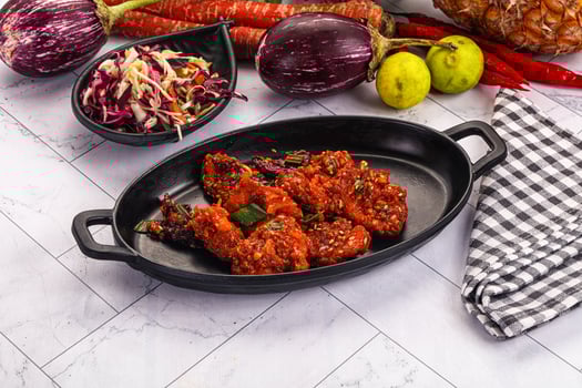 A table with a black dish with food on it photo