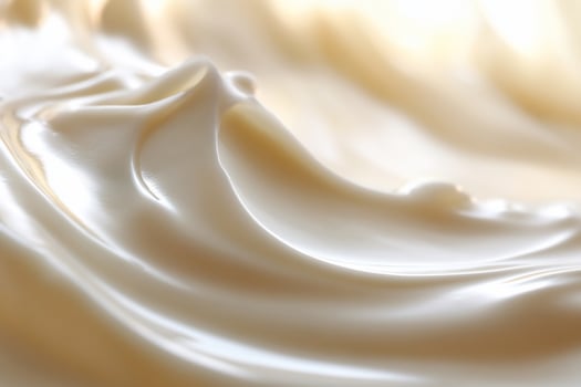 Close-up of creamy, swirling lotion texture. photo