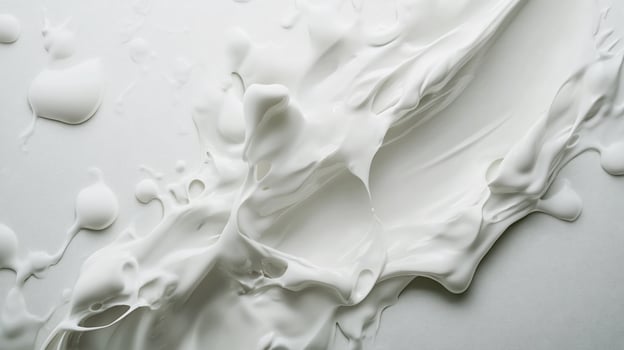 A close up of a white liquid splashing on a white surface photo