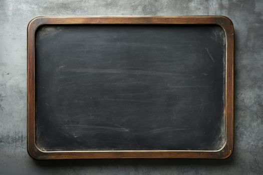 Empty black chalkboard framed in wood, ready for notes and drawings in an educational setting photo