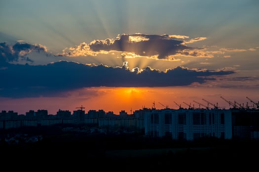 Cranes and buildings at sunset photo