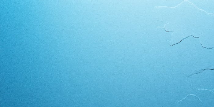 Textured blue background with subtle wrinkles and natural imperfections enhancing visual depth and interest photo