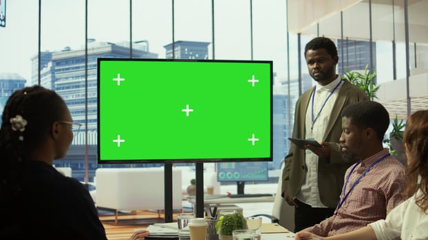 Employees and investors participating in a briefing next to isolated copy space display, reviewing economic indicators and performance metrics. Work team discussing finance planning. Camera B. photo