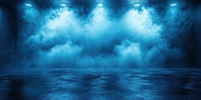 Mysterious blue fog envelops a darkened stage, creating an atmospheric setting for performance or event photo