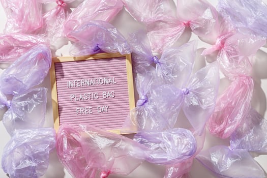 International Plastic Bag Free Day text on felt board with disposable plastic bags around. Waste reduction concept, zero waste, eco friendly, Sustainable life style, plastic free eco trend photo