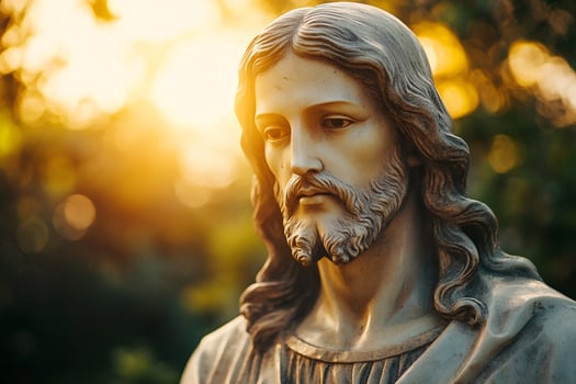 Bust of Jesus Christ statue looking down during golden hour photo