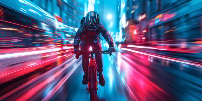 A male cyclist in a sleek black outfit speeds through a vibrant urban scene at night, surrounded by streaks of neon light. photo