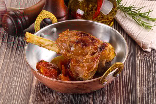A pan with meat and vegetables in it photo