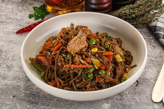 A bowl of noodles with meat and vegetables photo
