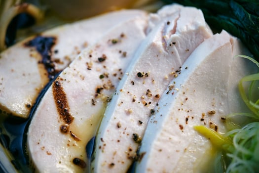Delicious ramen with chicken fillet slices in broth photo