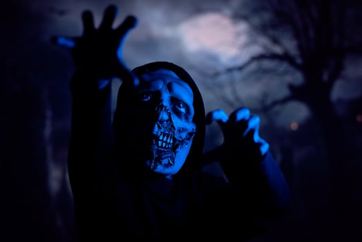 Scary zombie under blue neon light photo