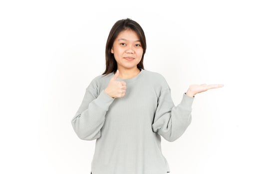A woman holding up her thumb and showing a thumbs up photo
