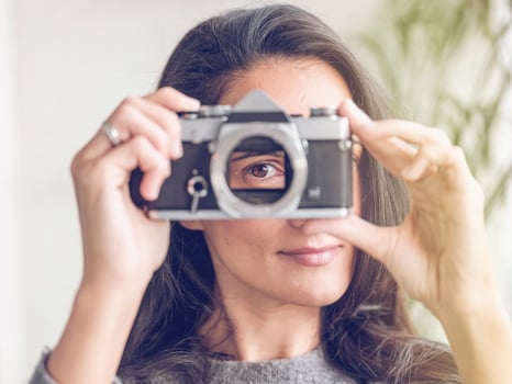 Content woman with retro film camera photo