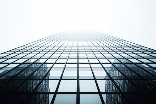 Modern skyscraper reaching into the foggy sky photo