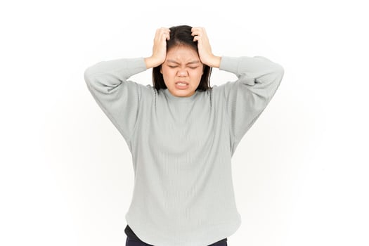 A woman is holding her head in her hands photo