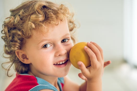 Smiling boy with small ball photo