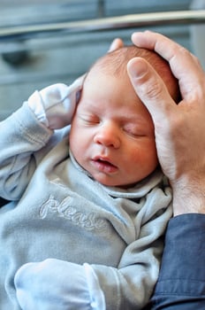 A man holding a baby in his arms photo