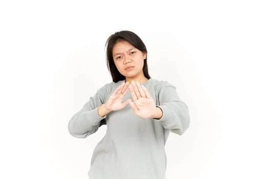 Asian woman making stop gesture on white background photo