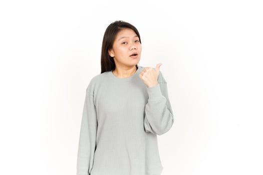 A woman in a gray sweatshirt pointing her finger photo
