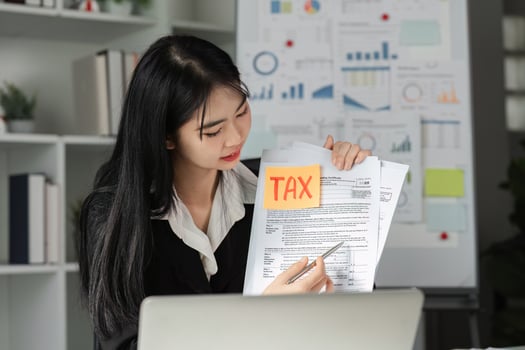 Accountant reviewing tax documents and filing with a focus on financial analysis. photo