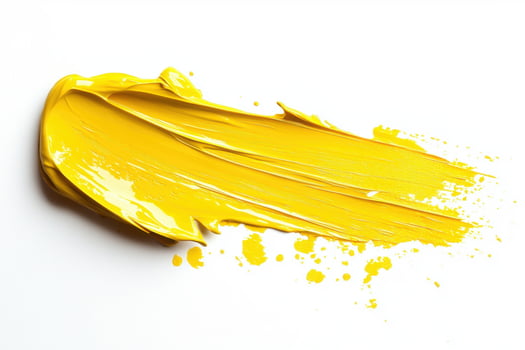 Yellow paint splattered on white during creative work photo