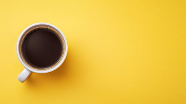 Simple coffee cup on yellow background photo