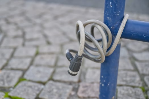 Coiled Electrical Cable on Blue Pole photo