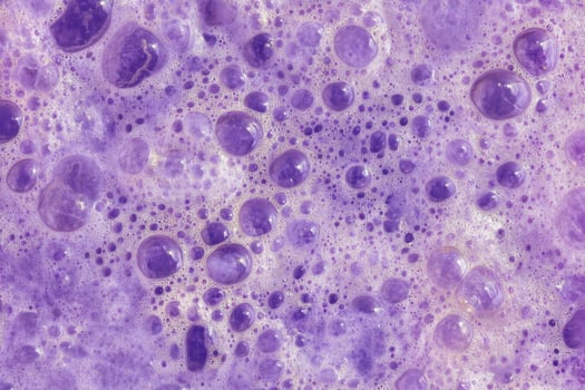 A close up of a purple surface with bubbles photo